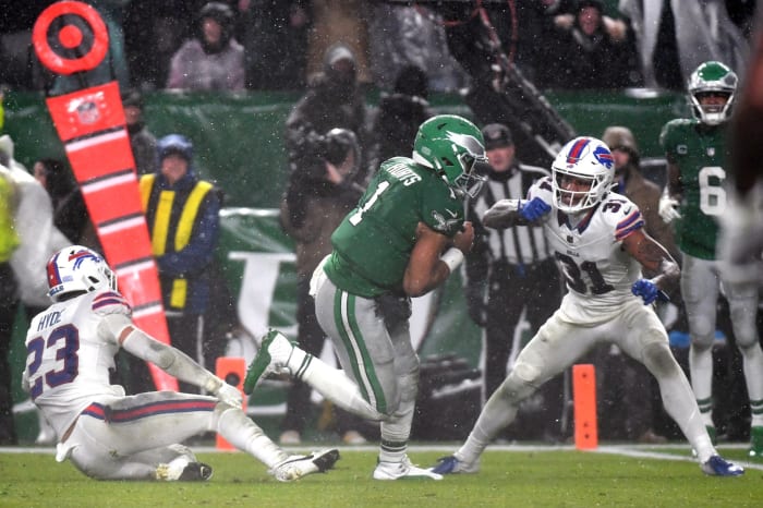 Nov 26, 2023; Philadelphia, Pennsylvania, USA; Philadelphia Eagles quarterback Jalen Hurts (1) scores the game-winning touchdown on a 12-yard run in overtime against Buffalo Bills safety Micah Hyde (23) and cornerback Rasul Douglas (31) at Lincoln Financial Field.